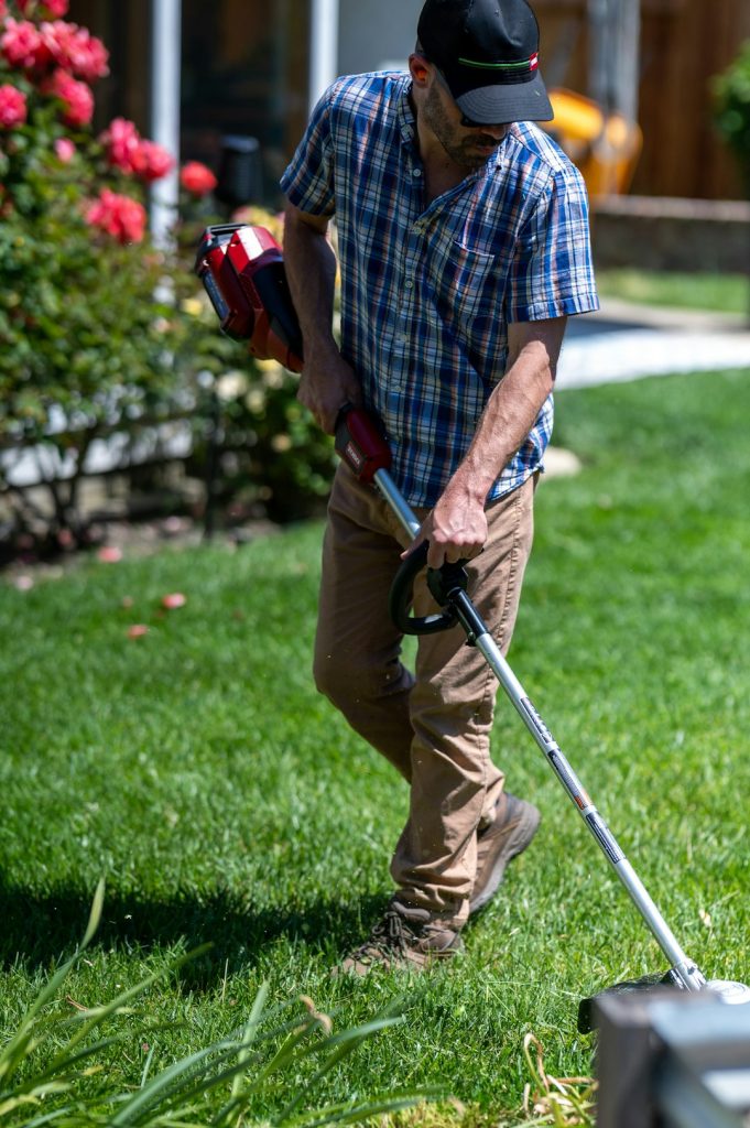 Jardinier qui tond une pelouse